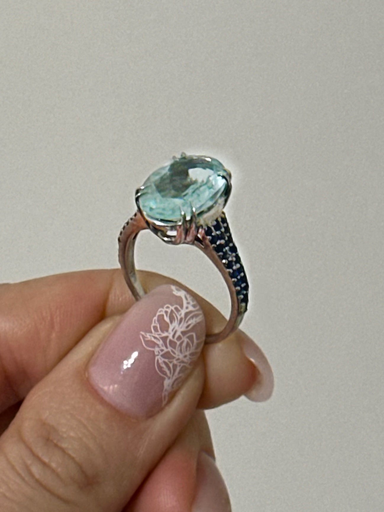 white rhodium plated Sterling silver ring with aquamarine and blue sapphires