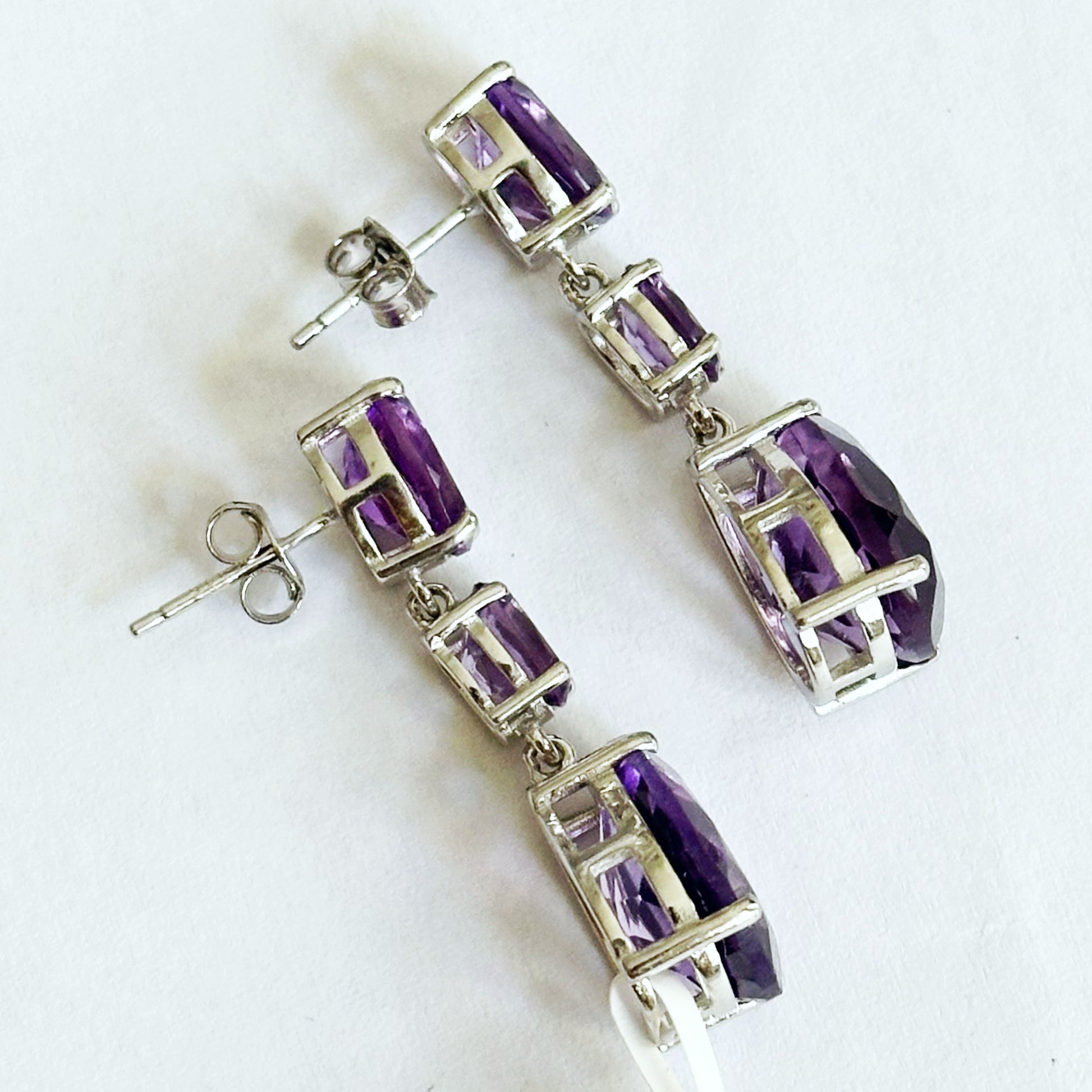 White rhodium plated sterling silver dangle earrings with natural amethysts