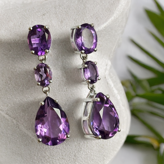 White rhodium plated sterling silver dangle earrings with natural amethysts