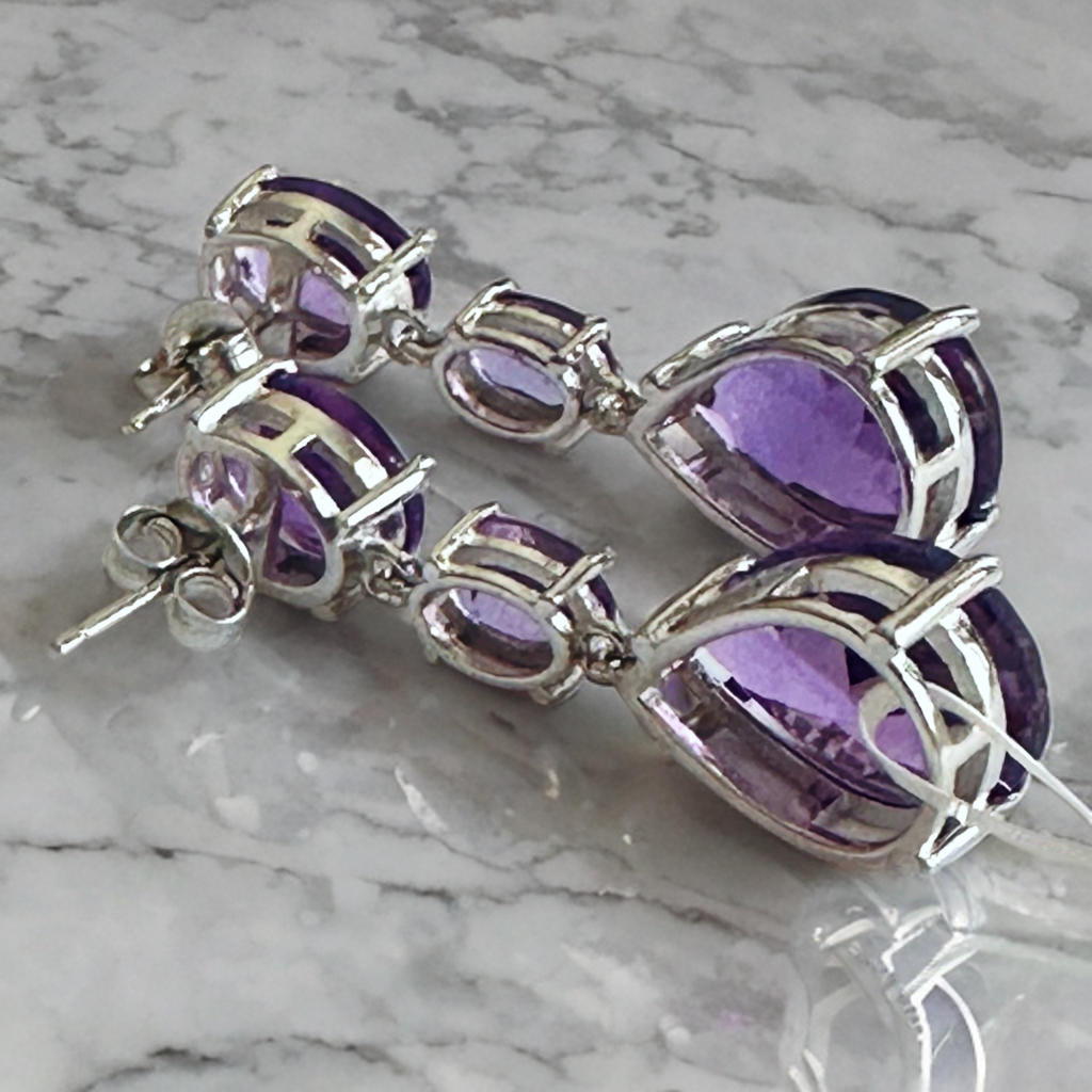 White rhodium plated sterling silver dangle earrings with natural amethysts