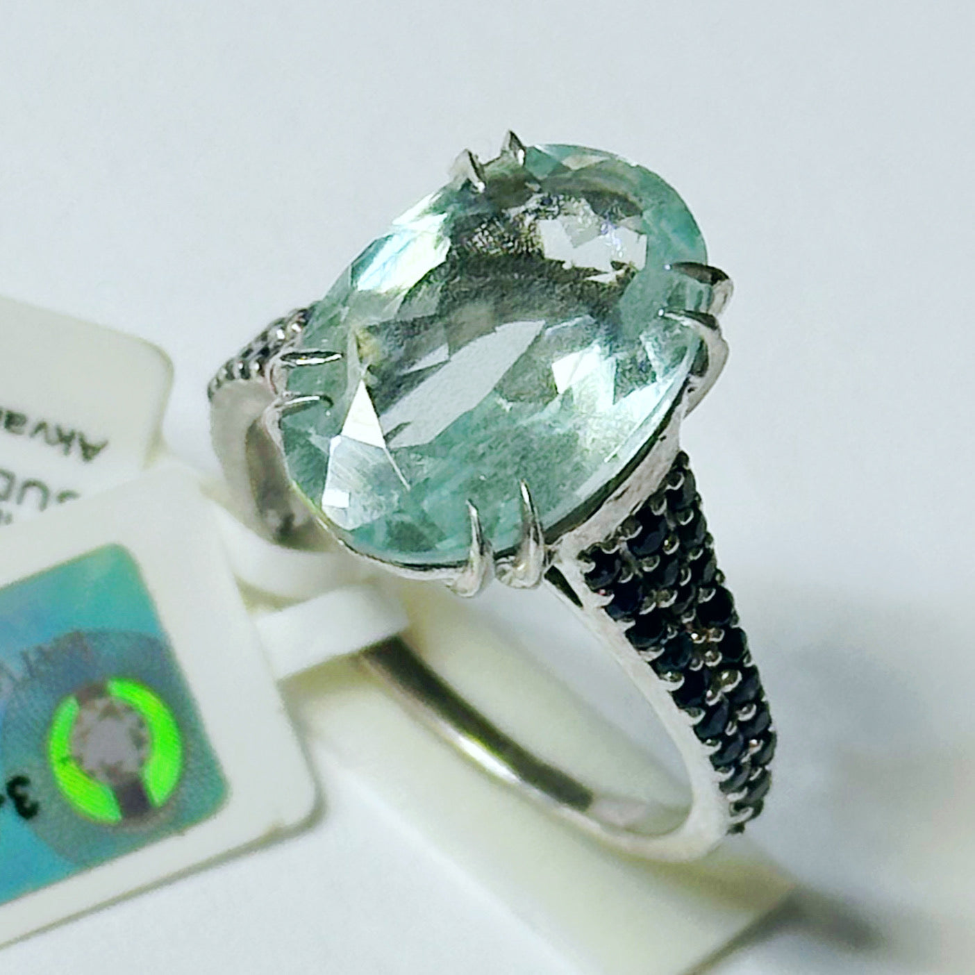 white rhodium plated Sterling silver ring with aquamarine and blue sapphires