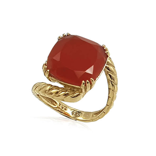 A silver ring with a large red chalcedony gemstone, featuring a twisted gold-tone band and a square-shaped ring head with a Faceted cut gem.